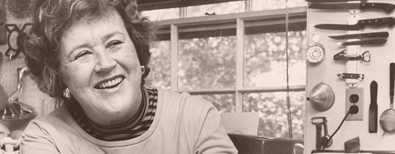 Smiling Julia Child in the kitchen, a true inspiration for late bloomers and proof that it’s never too late to start something new.